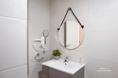 a bathroom with a sink and a mirror at JEREZ FERIA in Jerez de la Frontera