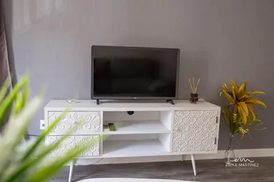 a tv sitting on top of a white entertainment center at JEREZ FERIA in Jerez de la Frontera