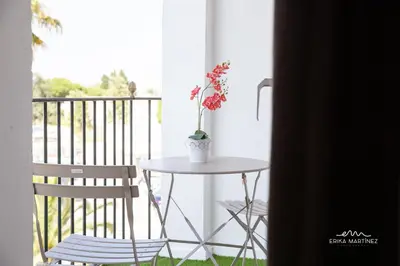 a table and a chair on a balcony at JEREZ FERIA in Jerez de la Frontera