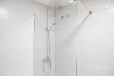a bathroom with a shower with a glass door at JEREZ FERIA in Jerez de la Frontera