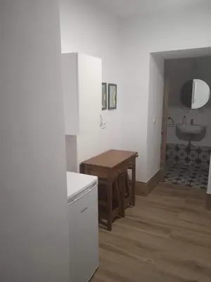 a kitchen with a table and a sink in a room at La Fuente Apartamento Jerez in Jerez de la Frontera