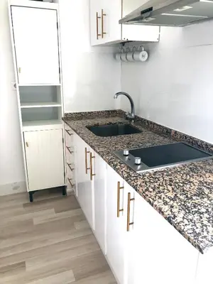 a kitchen with white cabinets and a sink at Valdelagrana vistas al mar, piscinas primera linea cadiz in El Puerto de Santa María