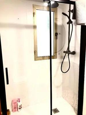 a shower with a glass door in a bathroom at Valdelagrana vistas al mar, piscinas primera linea cadiz in El Puerto de Santa María