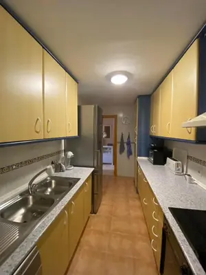 a kitchen with a sink and a refrigerator at Apartamento Costa de la Luz - Parking y Terraza in Chipiona