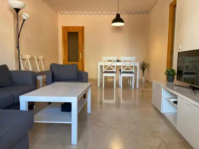 a living room with a couch and a table and a tv at Apartamento Costa de la Luz - Parking y Terraza in Chipiona
