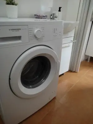 a white washing machine in a kitchen with a sink at El Tabanquito in Jerez de la Frontera