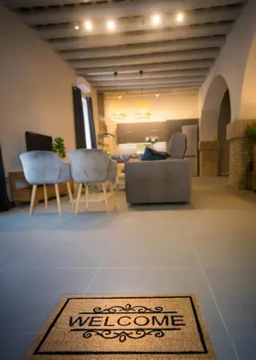 a living room with a welcome mat on the floor at LOFT LA CATEDRAL - Parking disponible in Jerez de la Frontera