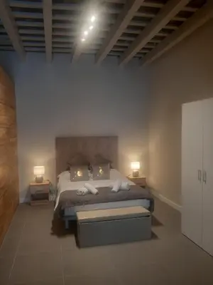 a bedroom with a bed with two lamps on it at LOFT LA CATEDRAL - Parking disponible in Jerez de la Frontera