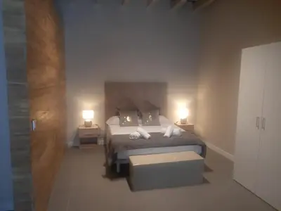 a bedroom with a bed with two white towels on it at LOFT LA CATEDRAL - Parking disponible in Jerez de la Frontera