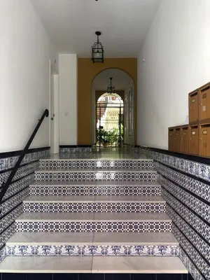 an empty hallway with stairs in a building at Apartamento Montefillo in Sanlúcar de Barrameda