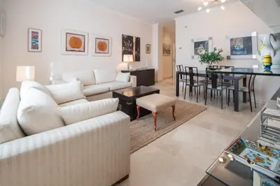 a living room with a white couch and a table at Apartamento El Meridiano de Cadiz in Cádiz
