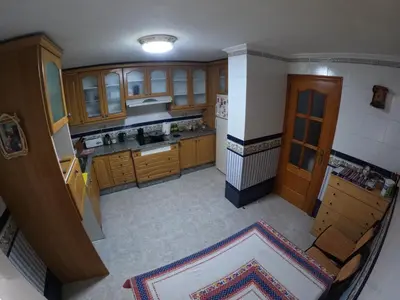 an overhead view of a kitchen with wooden cabinets at Comparte Espacio en Chiclana in Chiclana de la Frontera