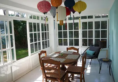a dining room with a table and chairs and windows at Chalet El Girasol in Chiclana de la Frontera