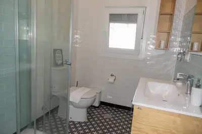 a bathroom with a toilet and a sink and a shower at Chalet El Girasol in Chiclana de la Frontera