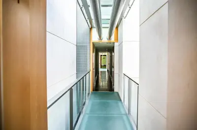 a hallway in a building with a green bench at Rota Mar in Rota