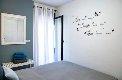 a bedroom with a bed with birds on the wall at Rota Mar in Rota