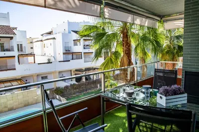 a balcony with a table and a palm tree at Rota Mar in Rota
