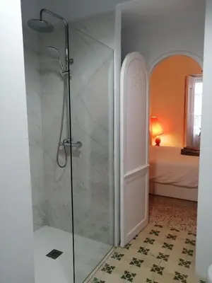 a shower with a glass door in a bathroom at HABITACION POLEO in Sanlúcar de Barrameda