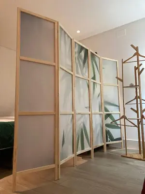 a room with wooden shelves with a painting on the wall at Apartamentos Turísticos La Plaza in Chipiona