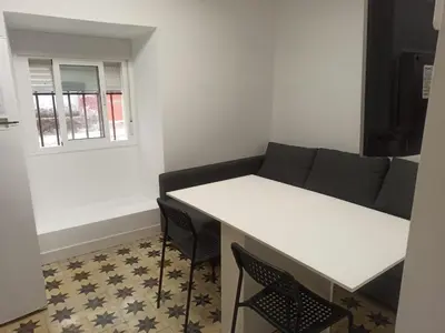 a living room with a couch and a table at Apartamento Nayca in Jerez de la Frontera