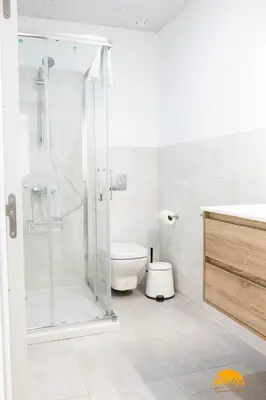a bathroom with a toilet and a glass shower at Nature Home by Cadiz Time in Cádiz