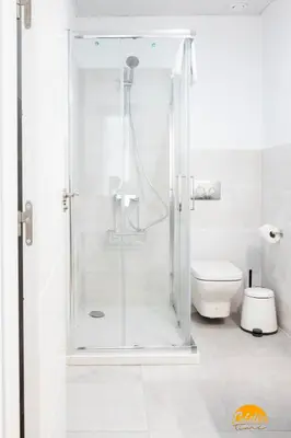 a white bathroom with a shower and a toilet at Nature Home by Cadiz Time in Cádiz