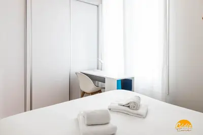 a bedroom with a bed with towels on it at Nature Home by Cadiz Time in Cádiz