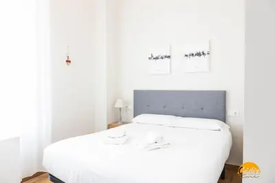 a white bedroom with a large white bed at Nature Home by Cadiz Time in Cádiz