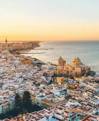 an aerial view of a city next to the ocean at El Patio de Santa María in Cádiz