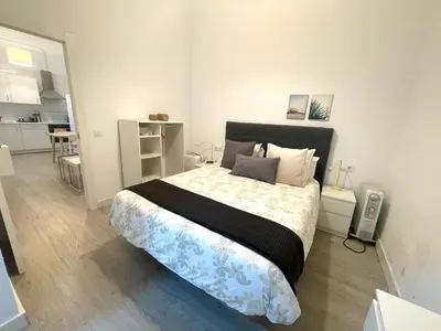 a bedroom with a large bed in a room at El Patio de Santa María in Cádiz