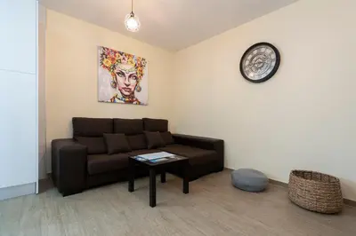 a living room with a couch and a table at Casa Caleta in Cádiz