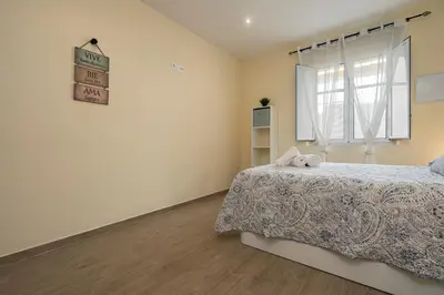 a bedroom with a bed and a window at Casa Caleta in Cádiz
