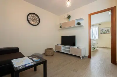a living room with a flat screen tv on a wall at Casa Caleta in Cádiz