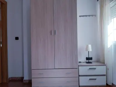 a large wooden cabinet in a room with a lamp at Cadiz Rented in Cádiz