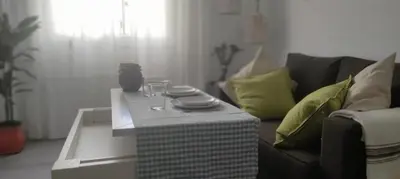 a living room with a couch and a table at Casa Mundaka in Sanlúcar de Barrameda
