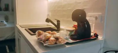 a kitchen counter with some pastries and a coffee maker at Casa Mundaka in Sanlúcar de Barrameda