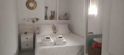 a bedroom with a bed with two towels on it at Casa Mundaka in Sanlúcar de Barrameda