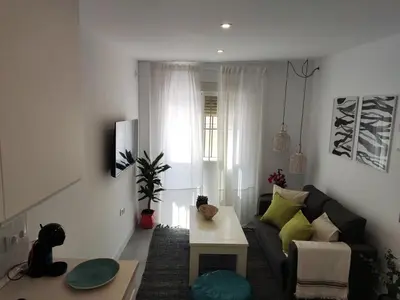 a living room with a couch and a table at Casa Mundaka in Sanlúcar de Barrameda