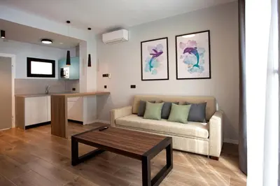 a living room with a couch and a table at Apartamentos La Espadaña in Rota