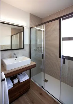 a bathroom with a sink and a shower at Apartamentos La Espadaña in Rota