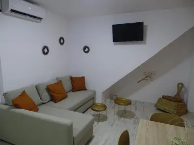 a living room with a couch and a table at Casasjerezanas Loft Aitana in Jerez de la Frontera