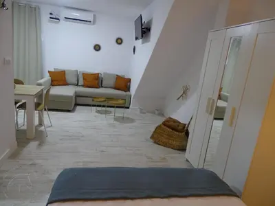 a living room with a couch and a table at Casasjerezanas Loft Aitana in Jerez de la Frontera