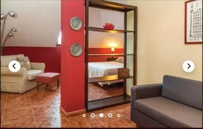 a living room with a mirror and a bed at HIDALMAR in Arcos de la Frontera