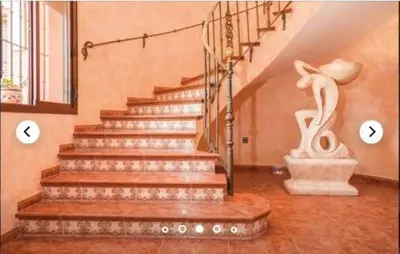 a staircase in a home with two pictures of the stairs at HIDALMAR in Arcos de la Frontera