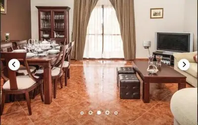 a dining room with a table and chairs and a television at HIDALMAR in Arcos de la Frontera