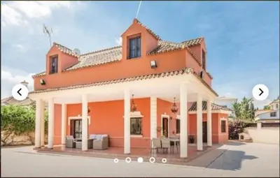 a large orange house with two circles in front of it at HIDALMAR in Arcos de la Frontera