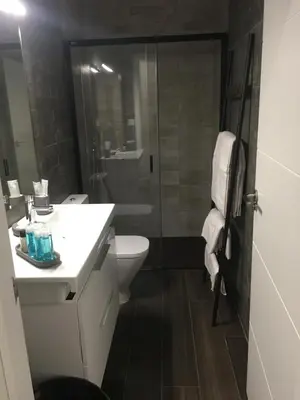 a bathroom with a toilet and a sink and a shower at VILLA ANYWAY CONIL Un lujo frente al mar in Conil de la Frontera