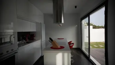a kitchen with white cabinets and a large window at VILLA ANYWAY CONIL Un lujo frente al mar in Conil de la Frontera