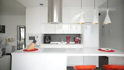 a kitchen with white cabinets and red chairs at VILLA ANYWAY CONIL Un lujo frente al mar in Conil de la Frontera