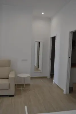 a living room with a couch and a table at APARTAMENTO LUPA in Cádiz